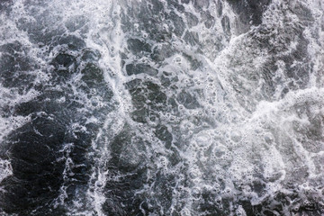 Fototapeta na wymiar Sea waves raging and splashing, abstract bubbles background