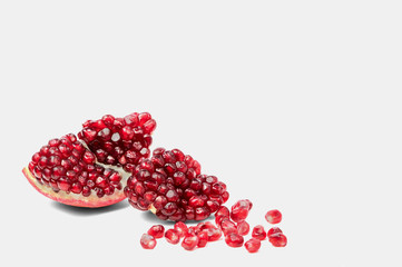 Pomegranate with scattered grain top view on white background
