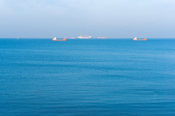 The calm sea. Ships on the horizon. Sea surface.