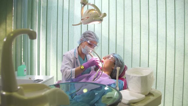 Dentist Cleans Patient's Teeth