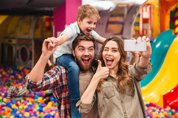 Smiling young family with their little son