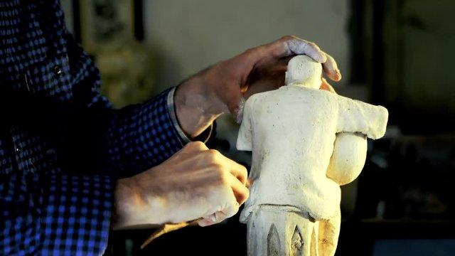 gypsum art sculpture making - Sculptor works musician statue from gypsum