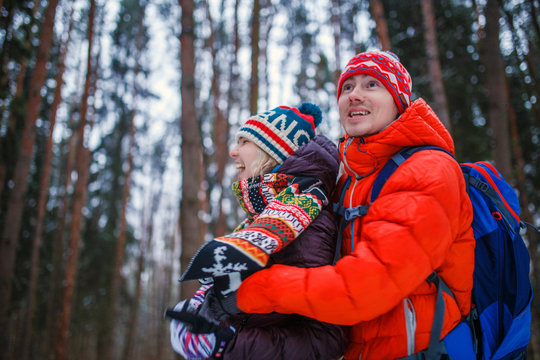 Photo of happy couple on walk in winter forest