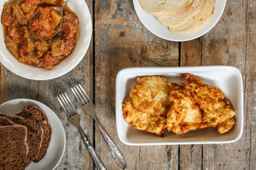 Meat deep-fried and eggplant and tomato salad on the table - meal