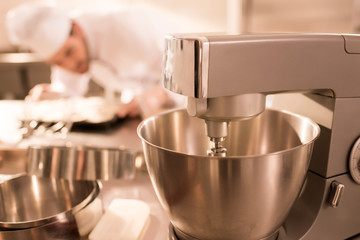 selective focus of confectioner and food processor whipping cream
