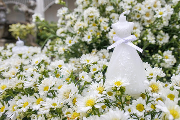 White wedding dress candle put in the cutter flower, luxury and beautiful for the wedding party.