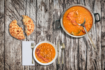 Beans Baked With Smoked Pork Ribs Served With Domestic Leavened Flatbread On Grunge Old Weathered Cracked Pine Wood Garden Table
