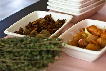 Dried anise and thyme, small onions in white bowls