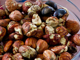Peeled large fresh chestnuts in a glass bowl