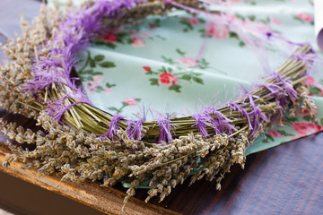Obraz na płótnie Canvas Hair ornament. A delicate wreath of dry lavender on a blue tablecloth