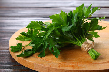 Fresh green parsley on the wooden table, selective focus.