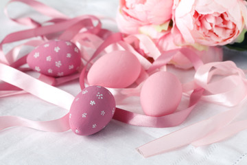 Festive easter eggs on table with ribbons