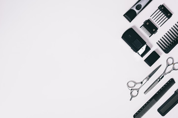 top view of arrangement of various barber tools isolated on grey