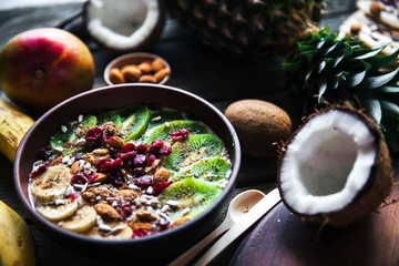 Yogurt with different fruits on a wooden background. Useful food, diet, organic.