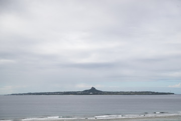 small island with mountains and sky