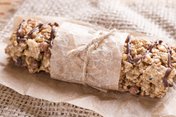 Chocolate Energy Bar with Fruits and Nuts. Useful sweetness consists of oatmeal, nuts, chocolate, honey.