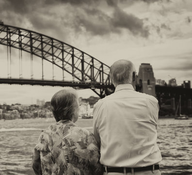 Elderly Couple Enjoy Sydney Harbour Bridge View At Sunset