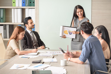 Businesswoman present financial chart with team in the meeting