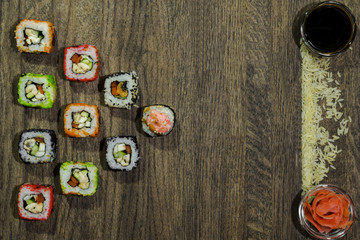 Obraz na płótnie Canvas Sushi background of backdrop. Sushi rolls are located in the left corner of the table.
