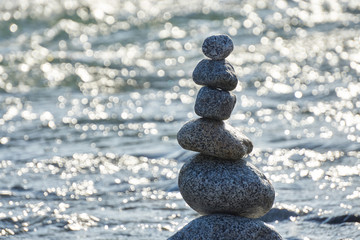 Stack of pebble stones over bokeh background. Concept zen, spa, summer, relax.