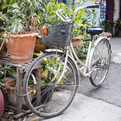 Fototapeta na wymiar Bicycle with basket is parked in street