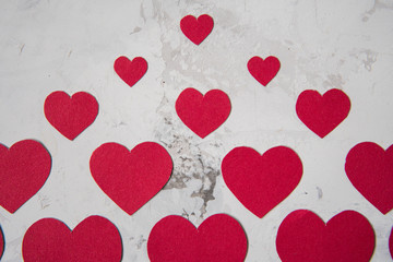 Red paper hearts on a white texture background