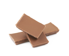 Pile of milk chocolate pieces isolated