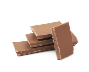 Pile of milk chocolate pieces isolated