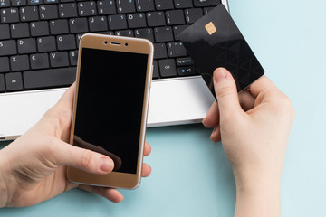 woman holding credit card on laptop for online shopping concept