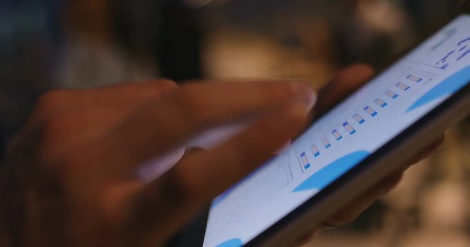 4k, Closeup of fingers swiping through financial charts. Slow motion.