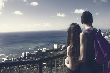young couple is hugging hawaii watching