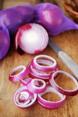 Red fresh onion and knife on the table