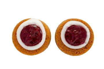 Runebergin torttu famous Finnish Runeberg cake tart pastry made of almonds, rum, raspberry jam. Close up macro top view of 2 caked isolated on white background Baked on February 5, Runeberg's birthday