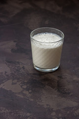 Milk in a glass beaker on a dark background