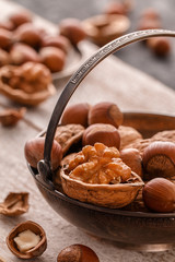 Different nuts on dark stone table. hazelnut,  walnuts.