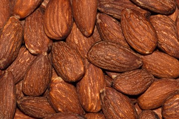 Shelled almonds food many scattered nuts closeup fruit organic produce brown healthy.