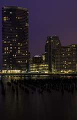Fototapeta na wymiar Jersey City, New Jersey skyline at twilight with skyscrapers illuminated over Hudson River