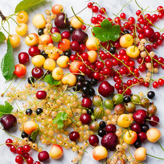 Fresh berries on a marble background. Top view.