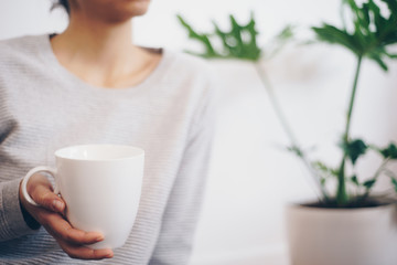 Hand holding coffee cup