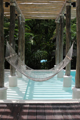 Fototapeta premium White hammock hanging over the pool in the resort.