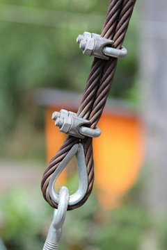 Closeup image of steel guy wire fittings installation.