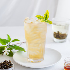 Ice green tea in glass fresh leaves. Copy space.