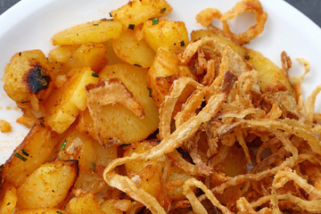 Close up portion of roasted potato with onion