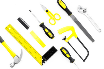 Repair tool kit. File, saw, hummer, corner ruler on white background top view pattern