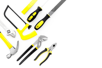Tools for repair and building. File, saw, hummer on white background top view copy space