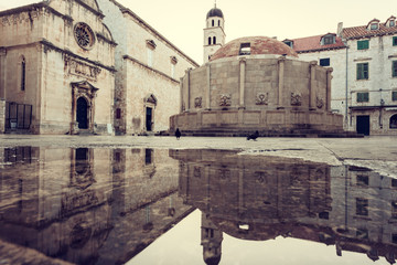 Old City of Dubrovnik. Historical town square with ancient architecture - big Onofrio fountain, church and monastery, popular tourist destination thanks to the fans of the Games of Thrones, Croatia