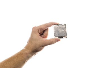 CPU with old thermal paste on IHS in man's hand isolated on white background.