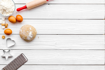 Make dough. Ingedients flour, eggs near cookware on white wooden background top view copy space