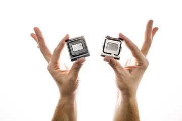 Delidded CPU with old thermal paste and glue in man's hand isolated on white background.