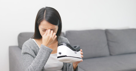 Woman feeling heahache after playing VR device